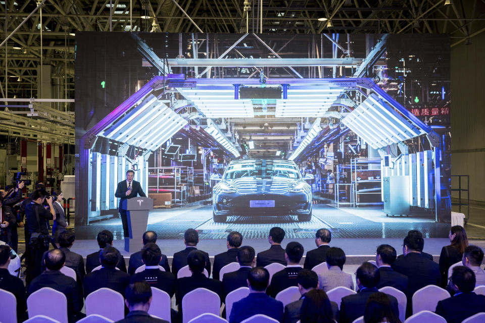 In this photo released by China's Xinhua News Agency, Tesla CEO Elon Musk speaks at a delivery ceremony for the first Tesla Model 3 cars made at Tesla's Shanghai factory in Shanghai, Tuesday, Jan. 7, 2020. Tesla's Shanghai factory delivered its first cars to customers Monday, and chief executive Elon Musk said the electric automaker plans to set up a design center in China to create a model for worldwide sales. (Ding Ting/Xinhua via AP)