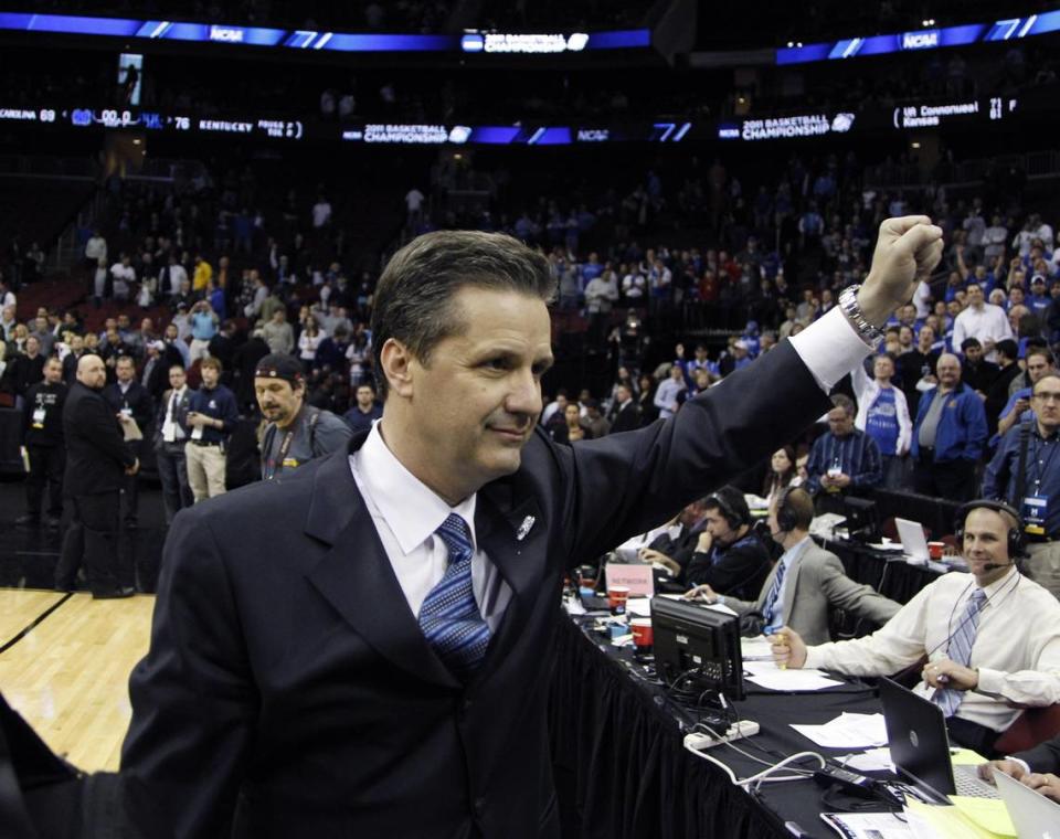 UK coach John Calipari raises a fist on his way to a radio interview at courtside after Kentucky beat North Carolina to advance to the NCAA Final Four in 2011.