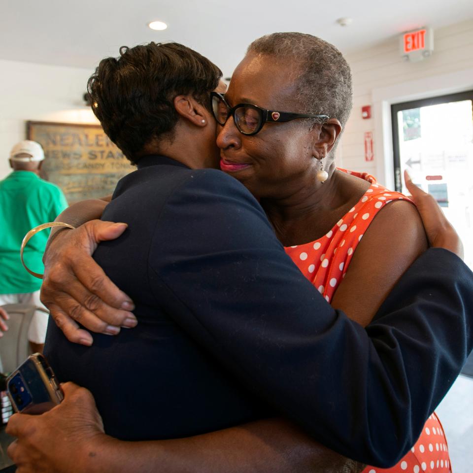 Former Framingham Mayor Yvonne Spicer, right, hugs state attorney general candidate Andrea Campbell during a campaign event at the Franklin St. Cafe on Franklin Street in Framingham, Aug. 12, 2022.