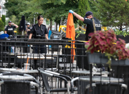 Police officers investigate a mass shooting on Danforth Avenue in Toronto, Canada, July 23, 2018. REUTERS/Chris Helgren