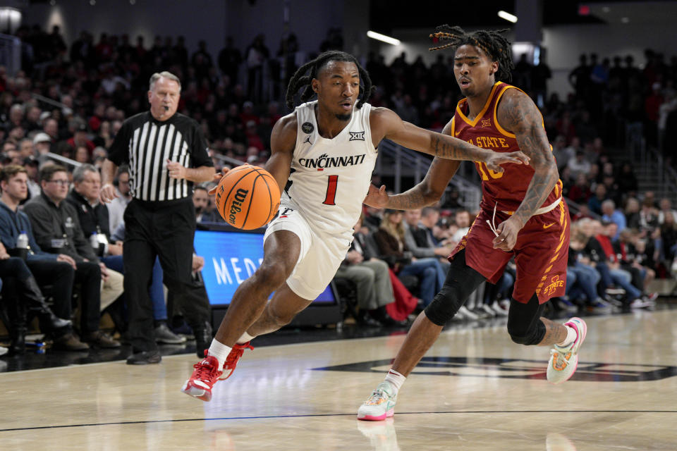 Cincinnati forward Kalu Ezikpe (1) drives against Iowa State's Keshon Gilbert during the first half of an NCAA college basketball game, Tuesday, Feb. 13, 2024, in Cincinnati. (AP Photo/Jeff Dean)