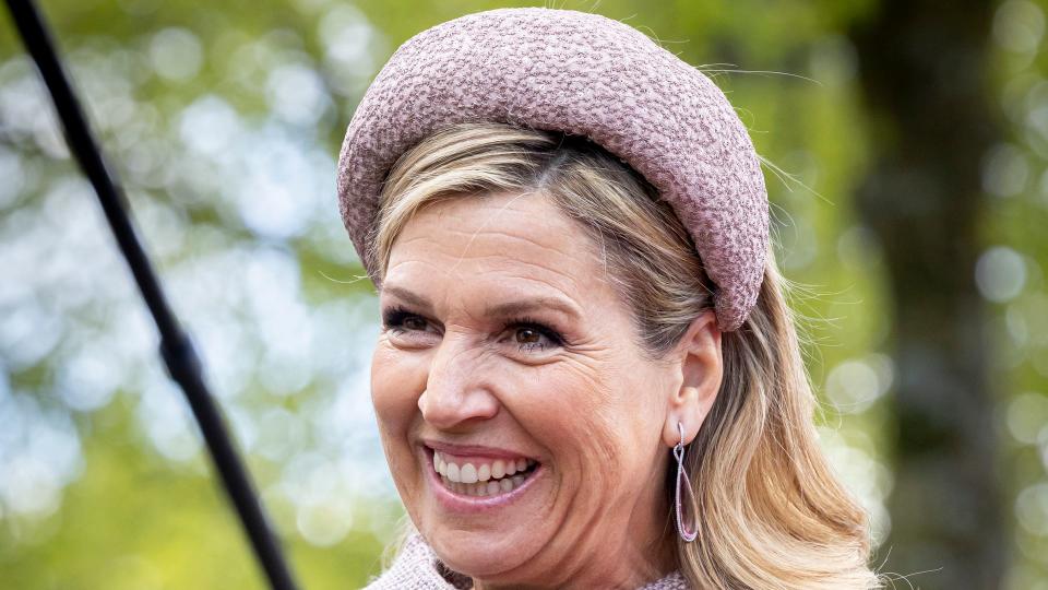 Queen Maxima wearing a tweed headband smiling