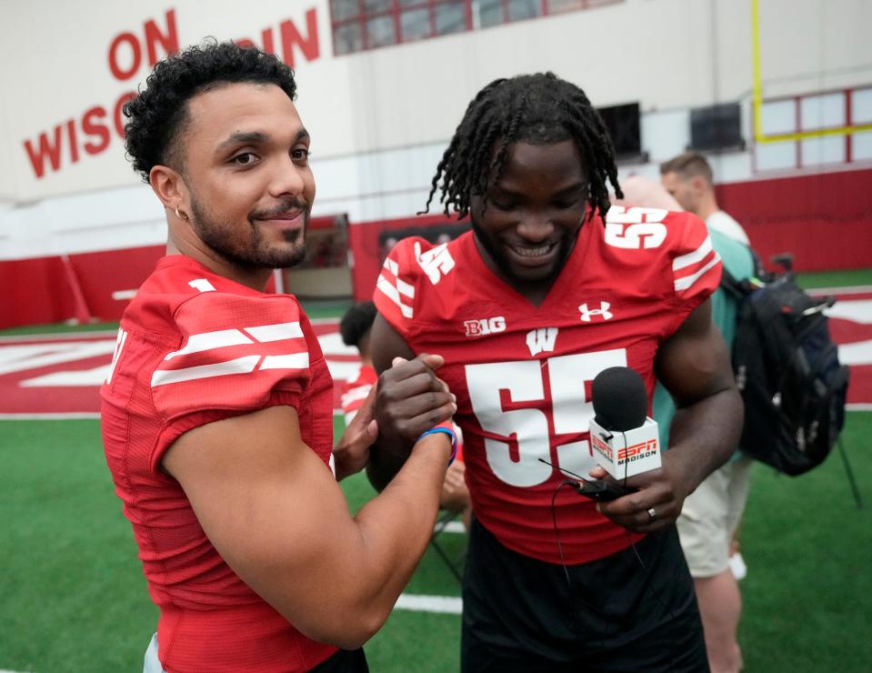 Wisconsin Badgers running back Chez Mellusi (1) and Wisconsin Badgers linebacker Maema Njongmeta (55) have a laugh while interviewing each other during Wisconsin Badgers football media day at Camp Randall Stadium in Madison on Tuesday, Aug. 1, 2023.  -  Mike De Sisti / The Milwaukee Journal Sentinel