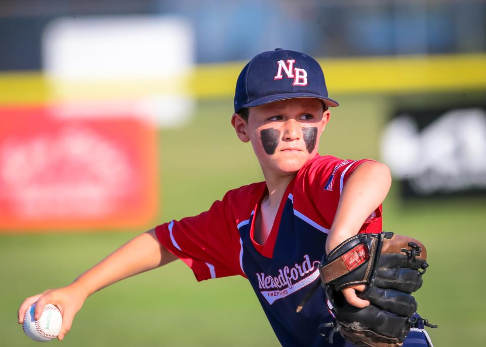 Ben Willis of N.B. Fire is all business as he delivers a pitch against Table 8 Restaurant at Brooklawn Park during Whaling City Youth Baseball League action.