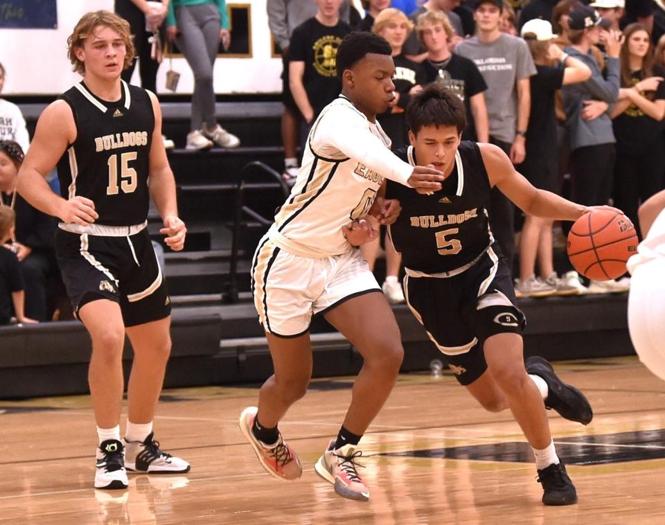 Clyde's Daijon Booker (5) brings the ball up court against Abilene High's Jatryan Smith in the second half. The Eagles beat Clyde 57-36 in the non-district game Tuesday at Eagle Gym.
