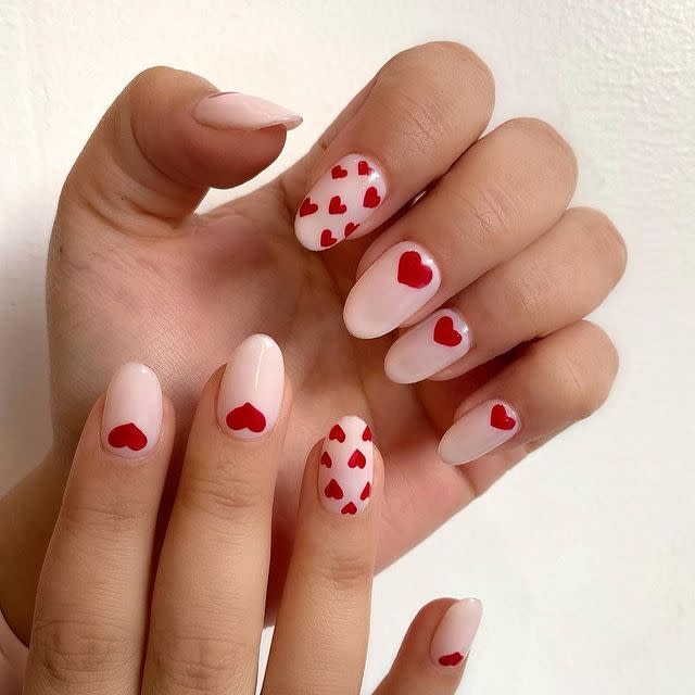 <p>It’s all in the details. You can’t go wrong with tiny red heart decals on each nail. Spice it up by having one nail with multiple hearts for some added flair.</p><p><a href="https://www.instagram.com/p/B8RMqghH1KM/" rel="nofollow noopener" target="_blank" data-ylk="slk:See the original post on Instagram;elm:context_link;itc:0;sec:content-canvas" class="link ">See the original post on Instagram</a></p>