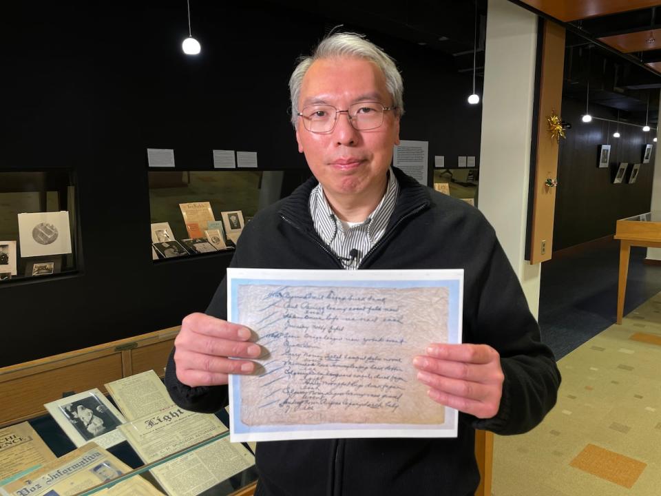 University of Manitoba research computer analyst holds a copy of the Silk Dress cryptograph.
