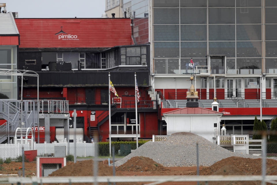 The grandstand near the finish line at Pimlico Race Course is seen empty, Friday, May 15, 2020, in Baltimore. The Preakness would have been run Saturday, May 16, 2020, in Baltimore. But Pimlico Race Course and many tracks across North America remain dark because of the coronavirus pandemic. (AP Photo/Julio Cortez)