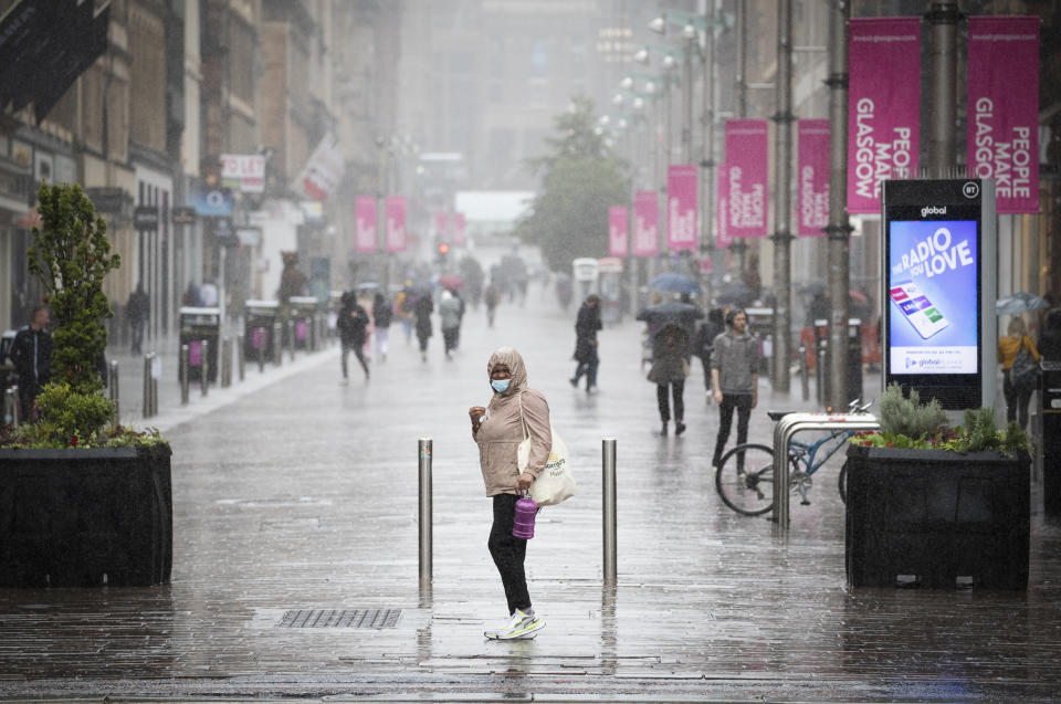 Members of the public caught in heavy rain in Glasgow city centre.