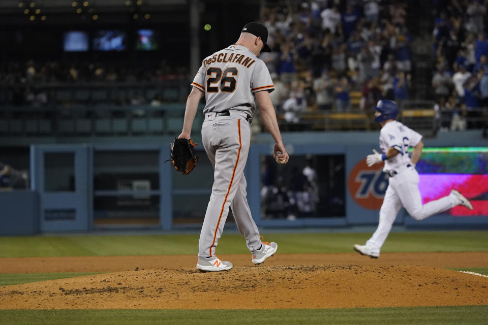 San Francisco Giants starting pitcher Anthony DeSclafani stands on the mound after giving up a two-run home run to Los Angeles Dodgers' Will Smith, right, during the fourth inning of a baseball game Thursday, July 22, 2021, in Los Angeles. (AP Photo/Marcio Jose Sanchez)