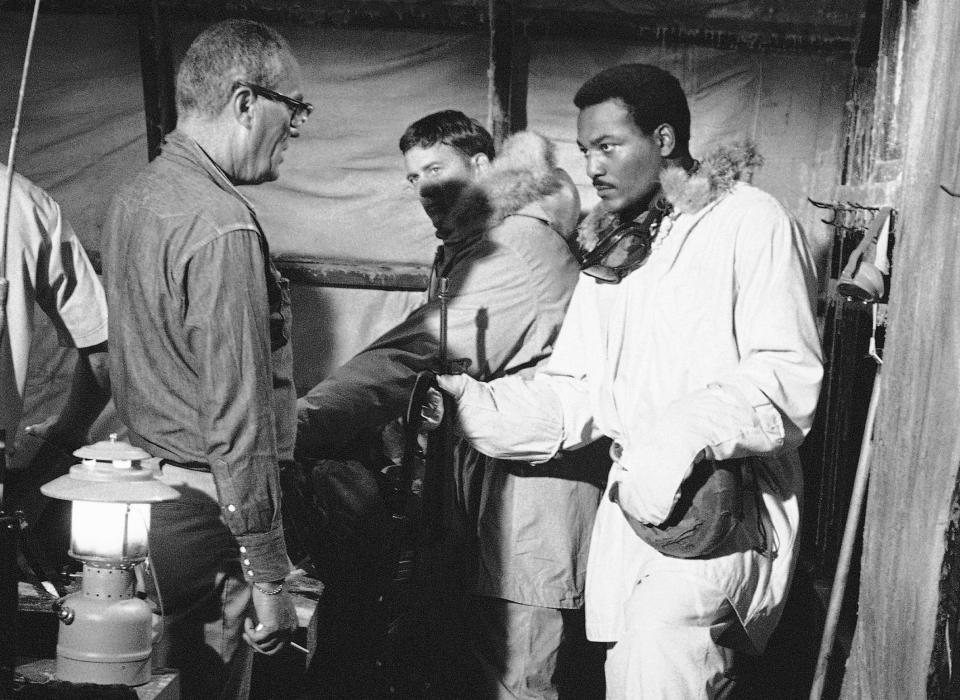 FILE - Football player Jim Brown, right, wearing the uniform of a Marine Captain for an upcoming film, Ice Station Zero, where he is directed by John Sturges on Nov. 6, 1967. NFL legend, actor and social activist Jim Brown passed away peacefully in his Los Angeles home on Thursday night, May 18, 2023, with his wife, Monique, by his side, according to a spokeswoman for Brown's family. He was 87. (AP Photo/File)