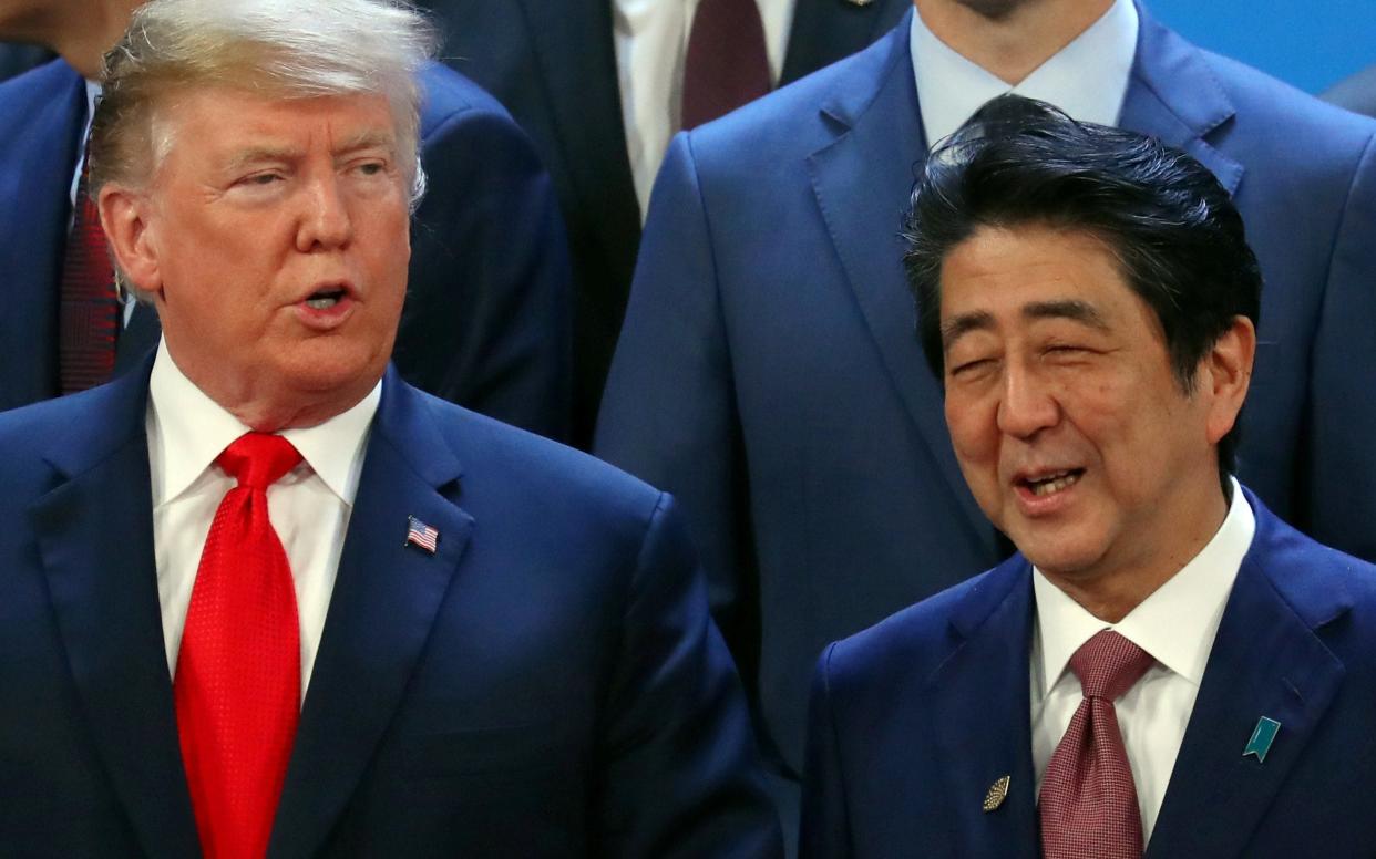 U.S. President Donald Trump and Japanese Prime Minister Shinzo Abe are seen before a family photo during the G20 summit in Buenos Aires - REUTERS