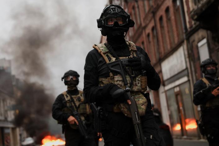 Officers stand guard during riots in Lille (REUTERS)