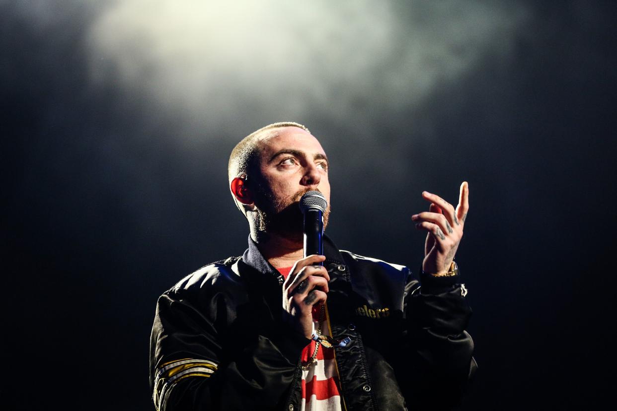 Mac Miller singing on stage. 