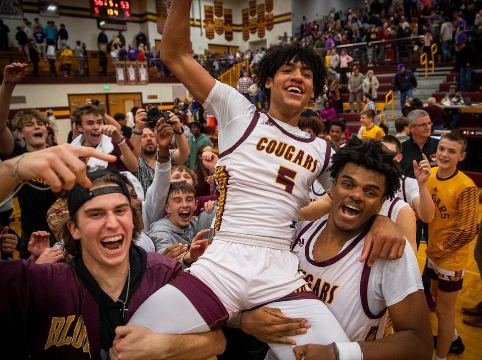 North's Jalen Williams (5) is lifted by Nehemiah Dangerfield (44) after Williams hit a game winning three pointer to defeat South 56-53 after the Bloomington North versus Bloomington South boys basketball game at Bloomington High School North on Friday, Jan. 5, 2024.