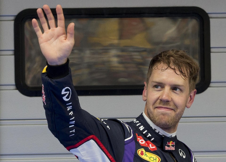 Red Bull Racing driver Sebastian Vettel of Germany waves to his fans after the qualifying session of the Chinese Formula One Grand Prix at Shanghai International Circuit in Shanghai, Saturday, April 19, 2014. Vettel takes third position for Sunday's Chinese Formula One Grand Prix race. (AP Photo/Andy Wong)