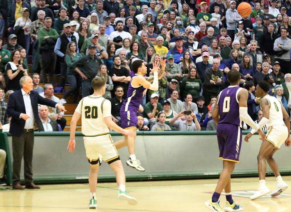 Albany's Sebastian Thomas tries to tie the game from halfcourt at the buzzer during the Great Danes 75-72 loss to Vermont in the America East quarterfinals on Saturday afternoon at UVM's Patrick Gym.
