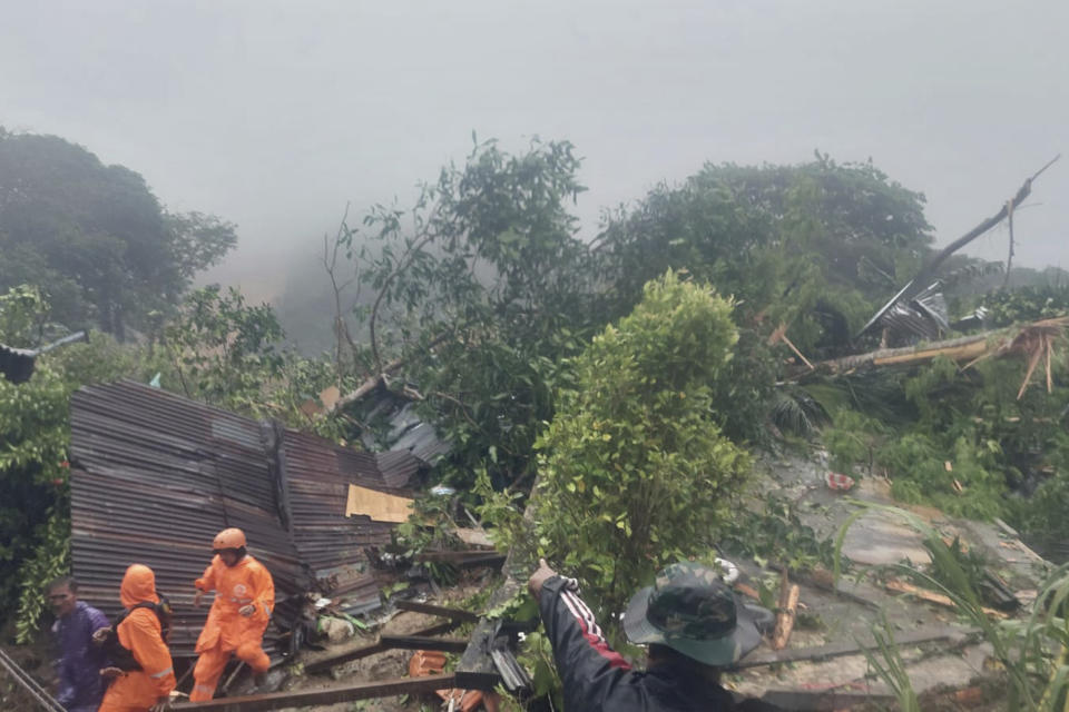 In this frame grab made from video released by Indonesia's National Disaster Management Agency (BNPB), rescuers search for victims at the site where a landslide hit a village on Serasan Island, Natuna regency, Indonesia on Monday, March 6, 2023. The landslide caused by torrential rain killed a number of people and left dozens of others missing on the remote island, disaster officials said. (BNPB via AP)