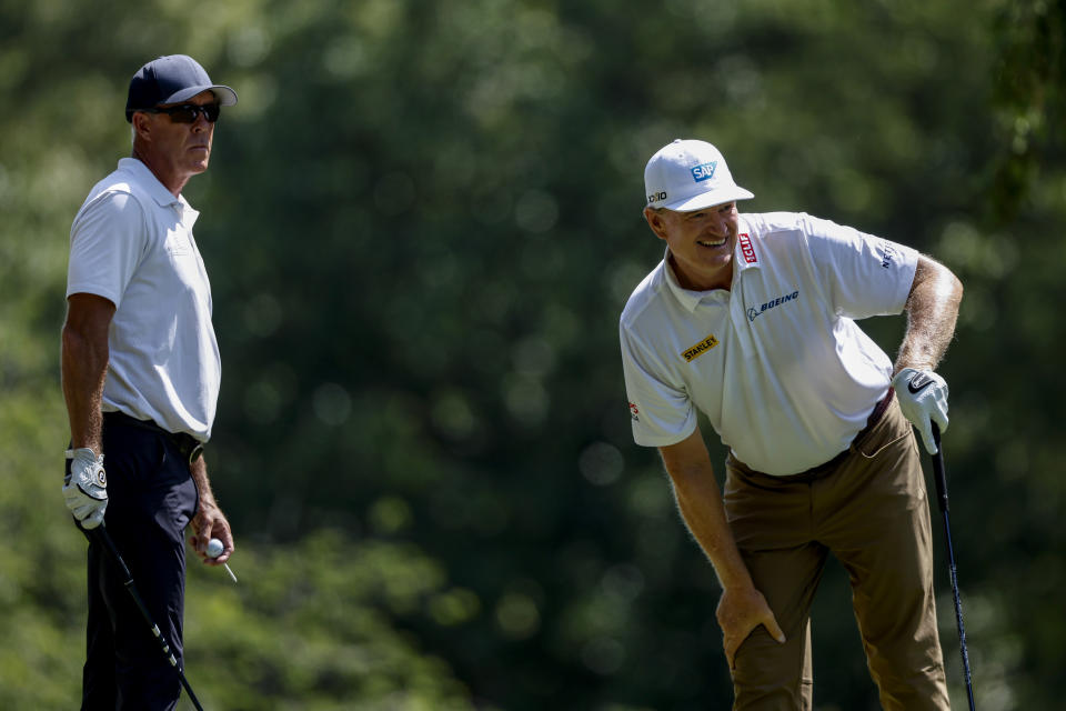 Ernie Els, right, of South Africa, watches his tee shot on the second hole as Richard Green, left, of Australia, looks on during the final round of a Champions Tour golf tournament, Sunday, May 14, 2023, in Hoover, Ala. (AP Photo/Butch Dill)