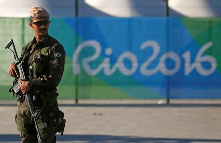 A special police forces officer stand guard outside the Olympic Park less than two weeks before the start of the Rio 2016 Olympic Games in the Barra da Tijuca neighborhood of Rio de Janeiro, Brazil, July 24, 2016. REUTERS/Pilar Olivares