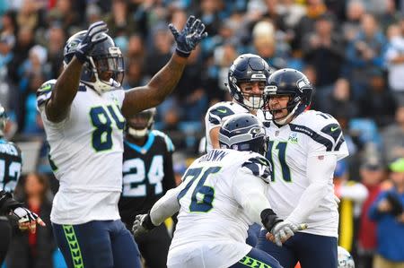 Nov 25, 2018; Charlotte, NC, USA; Seattle Seahawks kicker Sebastian Janikowski (11) celebrates with tight end Ed Dickson (84) and offensive tackle Duane Brown (76) after kicking the game winning field goal in the fourth quarter at Bank of America Stadium. Mandatory Credit: Bob Donnan-USA TODAY Sports