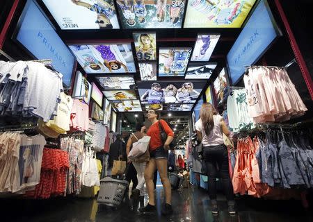 Customers shop at a Primark store on Oxford Street in London June 20, 2014. REUTERS/Luke MacGregor