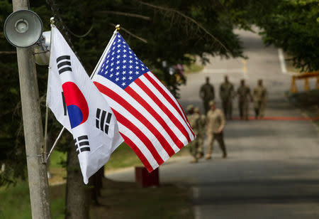 FILE PHOTO: The South Korean and American flags fly next to each other at Yongin, South Korea, August 23, 2016. Courtesy Ken Scar/U.S. Army/Handout via REUTERS