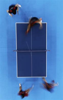 Japan's Kasumi Ishikawa and Ai Fukuhara plays against Erica Wu and Lily Zhang of the U.S. in their women's team first round table tennis match at the ExCel venue during the London 2012 Olympic Games August 3, 2012.