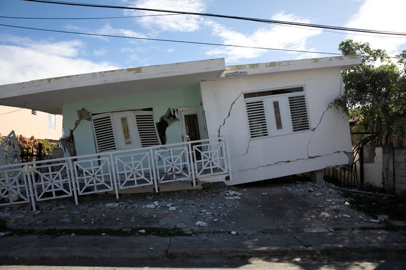 A house that collapsed on its foundation is seen after an earthquake in Guanica