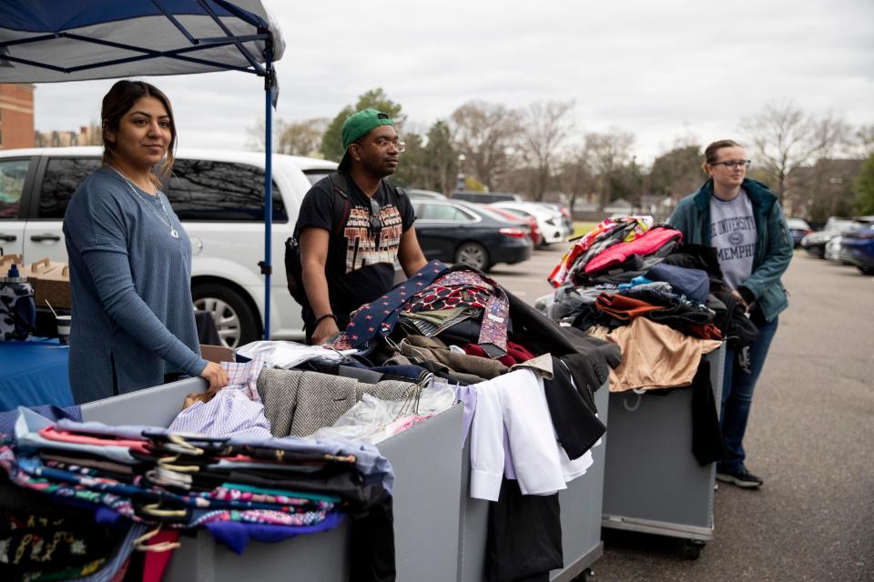 Amilet Cazares and D’Angelo Anderson, both first-generation students, and Nikaila Morrison, the program manager for the office of first-generation student success, watch as a car drives up to donate clothes for the career closet donation drive at the University of Memphis on Friday, March 8, 2024. The donation drive serves to give first-generation students access to professional clothing.