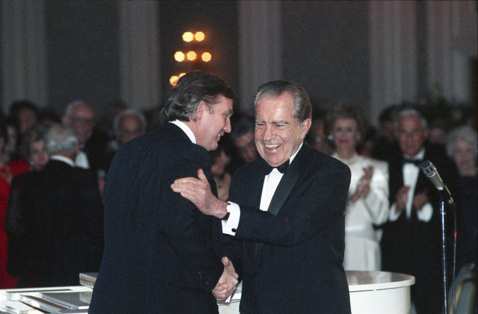 In this March 11, 1989, photo Donald Trump shakes hands with former President Richard Nixon at a tribute gala to Nellie Connally at the Westin Galleria ballroom in Houston, Texas. The letters between Trump and Nixon revealed for the first time in an exhibit that opens Thursday, Sept. 24, 2020, at the Richard Nixon Presidential Library & Museum, show the two men engaged in something of an exercise in mutual affirmation. The museum shared the letters exclusively with The Associated Press ahead of the exhibit’s opening. (Richard Carson/Houston Chronicle via AP)