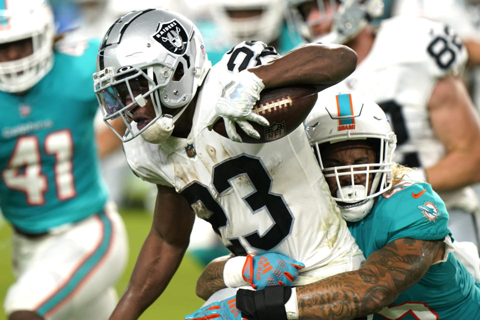 Miami Dolphins linebacker Duke Riley (45) tackles Las Vegas Raiders running back Kenyan Drake (23) during the first half of a NFL preseason football game, Saturday, August 20, 2022, in Miami Gardens, Fla. (AP Photo/Wilfredo Lee)