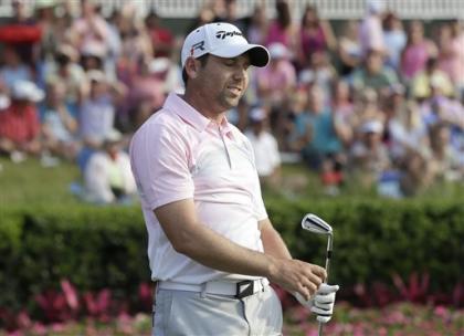 Sergio Garcia reacts as his tee shot on the 17th hole goes into the water. (AP)