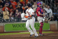 Houston Astros' Christian Vazquez (9) celebrates after hitting a home run as Philadelphia Phillies catcher Garrett Stubbs stands behind home plate during the seventh inning of a baseball game Wednesday, Oct. 5, 2022, in Houston. (AP Photo/David J. Phillip)