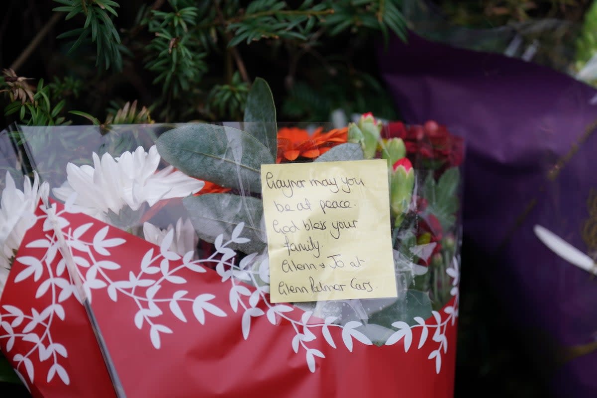 Floral tributes began to be laid near the gates of Wensum Park, with three bunches left by 3pm on Friday (PA)