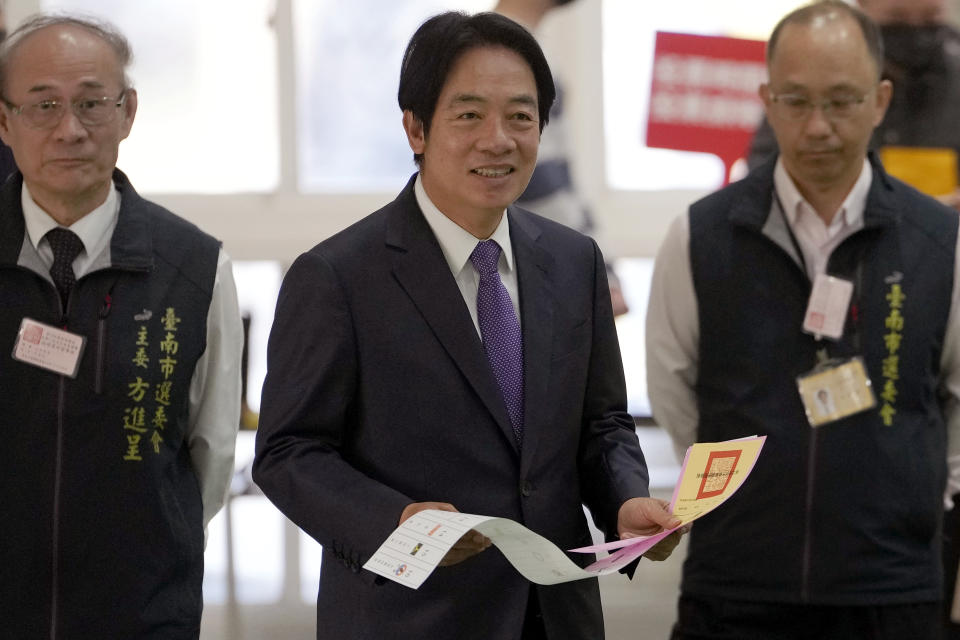 Democratic Progressive Party presidential candidate Lai Ching-te, center, who also goes by William, walks with ballot papers to cast at a polling station in southern Taiwan's Tainan city on Saturday, Jan. 13, 2024. Taiwanese are casting their votes Saturday for a new president in an election that could chart the trajectory of its relations with China over the next four years.(AP Photo/Ng Han Guan)