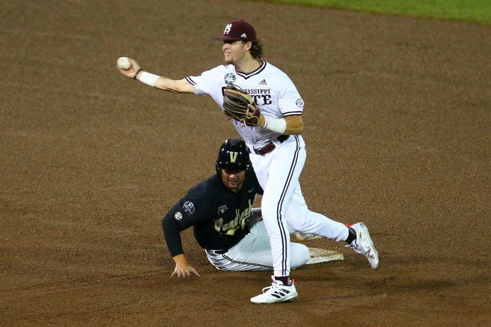 Mississippi State shortstop Lane Forsythe forces out Vanderbilt's Tate Kolwyck, left, at second base during the fourth inning in Game 2 of the NCAA College World Series baseball finals, Tuesday, June 29, 2021, in Omaha, Neb. (AP Photo/John Peterson)