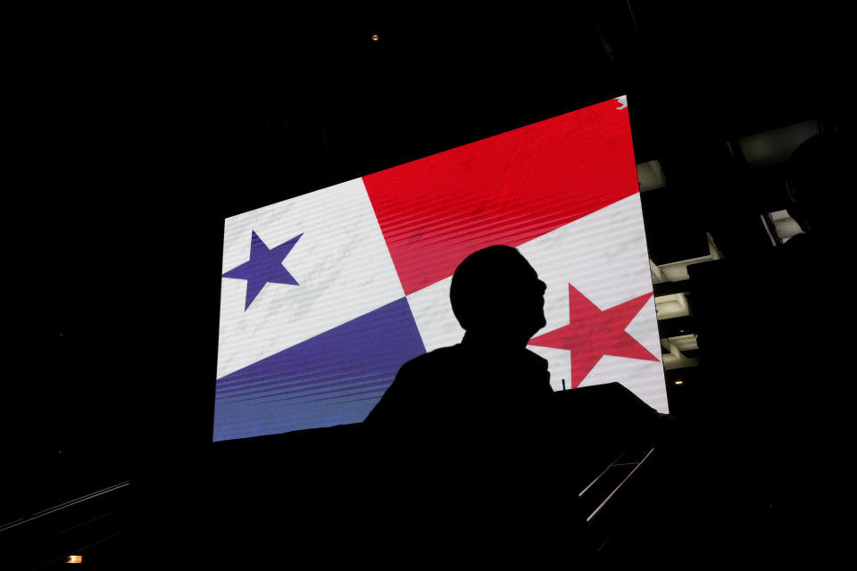 A supporter of Achieving Goals presidential candidate Jose Raul Mulino stands near a screen outside his campaign headquarters as he waits for the results of the general elections in Panama City, Sunday, May 5, 2024. (AP Photo/Matias Delacroix)