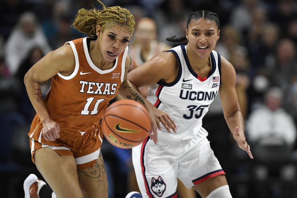 Texas' Sonya Morris (11) and Connecticut's Azzi Fudd (35) chase the ball during the first half of an NCAA college basketball game, Monday, Nov. 14, 2022, in Storrs, Conn. (AP Photo/Jessica Hill)