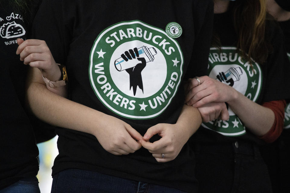 FILE - Starbucks employees and supporters react as votes are read during a union-election watch party on Thursday, Dec. 9, 2021, in Buffalo, N.Y. It’s become a common sight: jubilant Starbucks workers celebrating after successful votes to unionize at dozens of U.S. stores. But when the celebrations die down, a daunting hurdle remains. To win the changes they seek, like better pay and more reliable schedules, unionized stores must sit down with Starbucks and negotiate a contract. It’s a painstaking process that can take years. (AP Photo/Joshua Bessex, File)