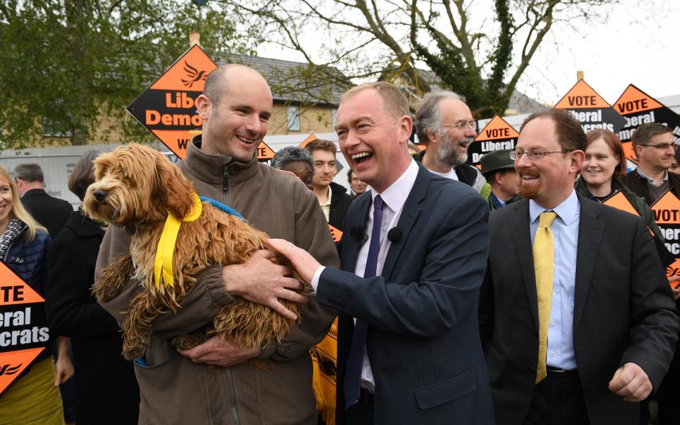 Tim Farron meets the dog - Credit: EPA/FACUNDO ARRIZABALAGA