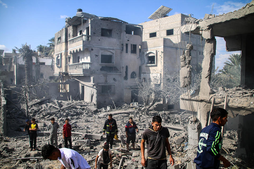 Palestinian emergency services and local citizens search for victims in buildings destroyed during Israeli air raids in the southern Gaza Strip on October 18, 2023 in Khan Yunis, Gaza.
