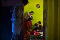 <p>Gabriela Ovid and her husband, Jorge, both from Romania, get their children ready for school as they wait for the police to arrive to evict them in Madrid, June 10, 2014. (AP Photo/Andres Kudacki) </p>