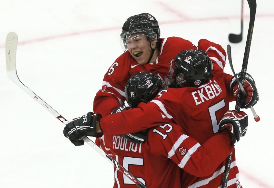 Canada's Ekblad celebrates his goal against the Czech Republic with teammates Lazar and Pouliot period of their IIHF World Junior Championship ice hockey game in Malmo