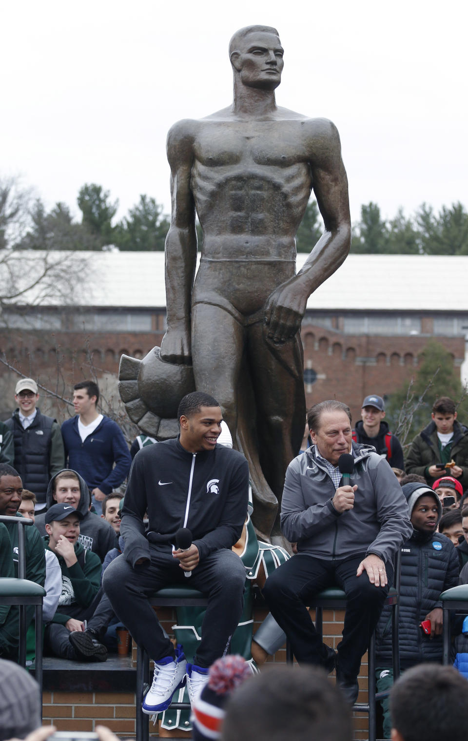 Michigan State's Miles Bridges, left, listens as men's basketball coach Tom Izzo, right, speaks during an NCAA college basketball news conference, Thursday, April 13, 2017, in East Lansing, Mich. Bridges, a 6-foot-7 forward from Flint, Mich., announced he is returning for his sophomore season. (AP Photo/Al Goldis)