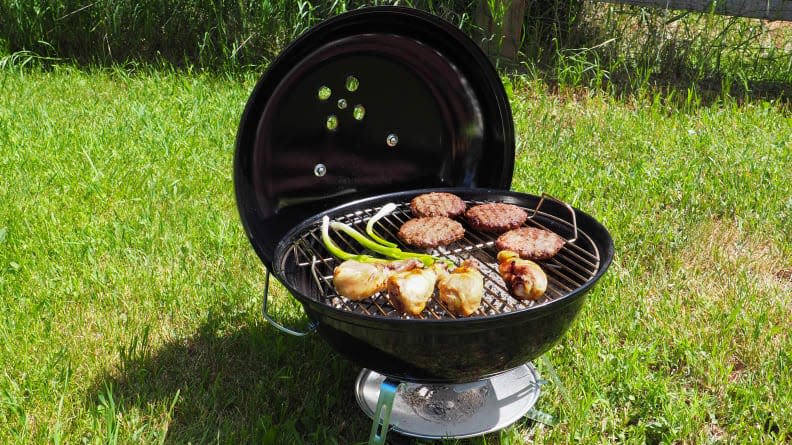 Black portable grill in the grass