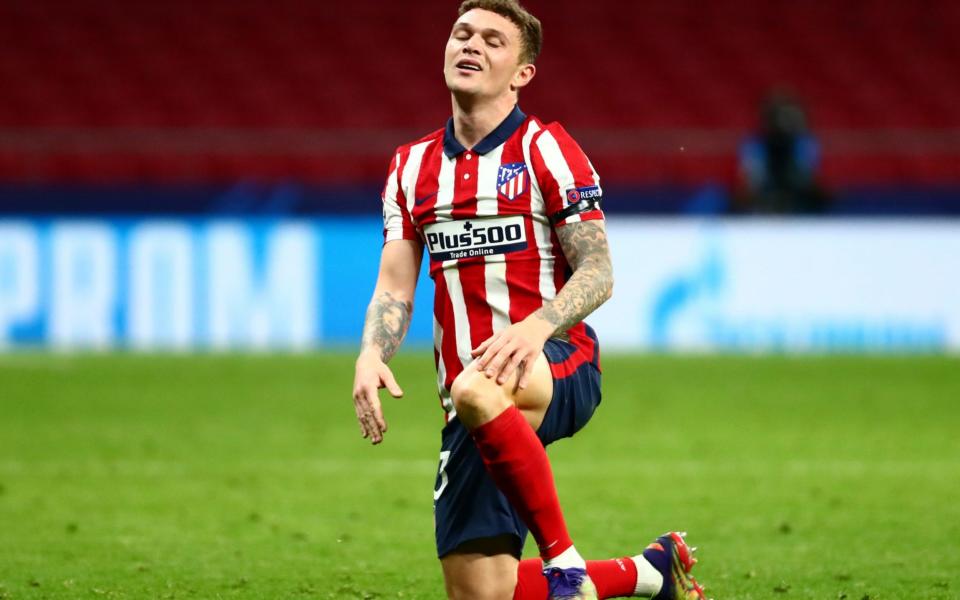 Kieran Trippier kneels and grimaces on football pitch - REUTERS