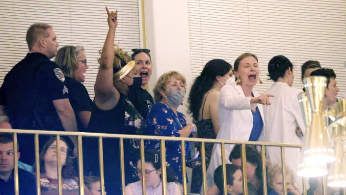 Security removes abortion rights protesters Tuesday, May 16, 2023, in Raleigh, N.C., when they got vocal after North Carolina House members voted to override Democratic Gov. Roy Cooper's veto of a bill that would change the state's ban on nearly all abortions from those after 20 weeks of pregnancy to those after 12 weeks of pregnancy. Both the Senate and House had to complete successful override votes for the measure to be enacted into law. The Senate voted to override the veto earlier and the House also voted to override. (AP Photo/Chris Seward)