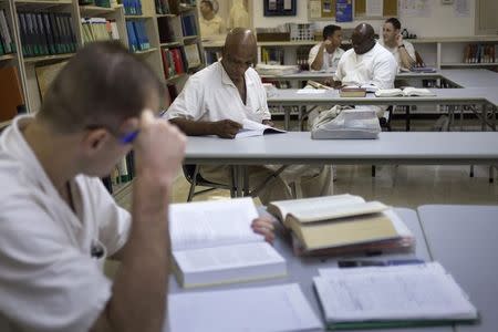 Offenders read books and write papers at a library inside the Southwestern Baptist Theological Seminary located in the Darrington Unit of the Texas Department of Criminal Justice men's prison in Rosharon, Texas August 12, 2014. REUTERS/Adrees Latif