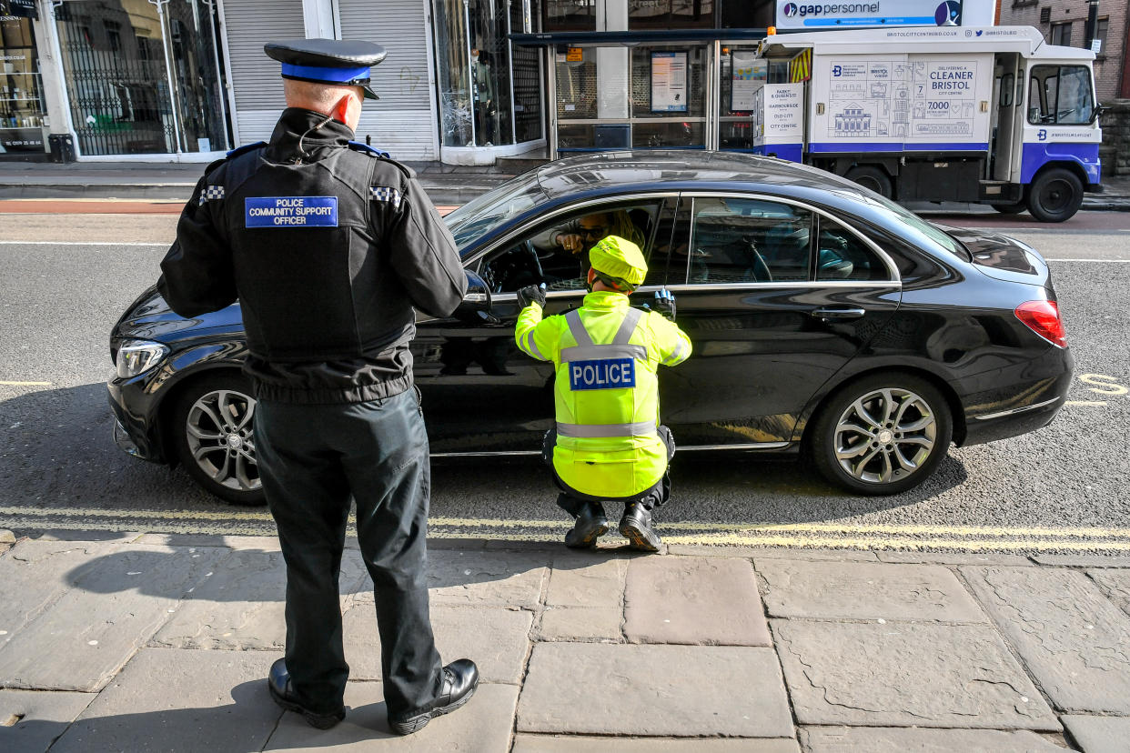 Police stop motorists as they travel on Park Street, Bristol, where random checks on essential travel are taking place as the UK continues in lockdown to help curb the spread of the coronavirus.